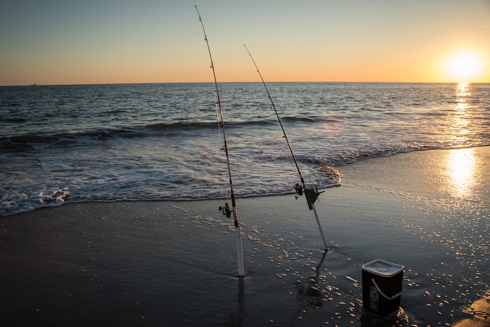 A couple of surf fishing rods in the sand
